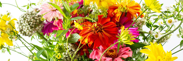 Summer bouquet of colorful Zinnia, onion inflorescences and mint sprigs, Rudbeckia Goldquelle and red clover, Ranunculus and Matricaria, home decoration with flowers banner
