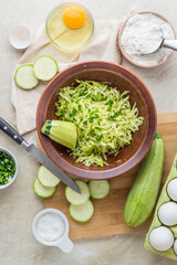cooking process of zucchini fritters, vegan dish, top view
