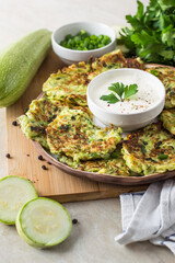 zucchini fritters, vegan zucchini pancakes, fresh herbs and sauce
