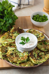 zucchini fritters, vegan zucchini pancakes, fresh herbs and sauce

