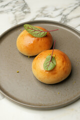 Brioche buns on a grey plate. Fresh pastry buns