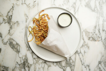 Crispy zucchini sticks served with sour cream sauce