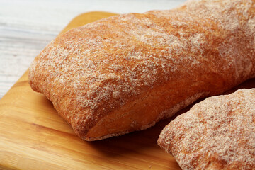 Two bread buns on wooden board close up