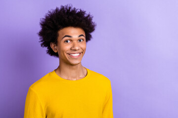 Portrait of cool cheerful happy young man funny chevelure hair wearing yellow t-shirt macho smiling isolated on violet color background