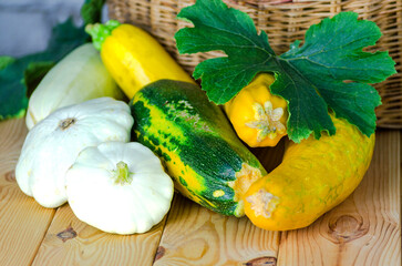 fresh zucchini and squash in a wicker basket