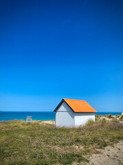 Fototapeta na wymiar Orange beach hut on the coast