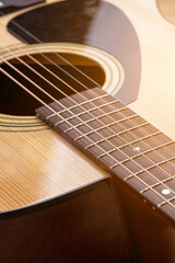 Obraz premium Classical guitar close up. Acoustic guitar on wood background.Music instrument concept
