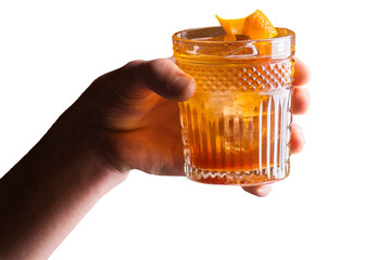 Bartender holds an orange cocktail with orange peel - 628154186