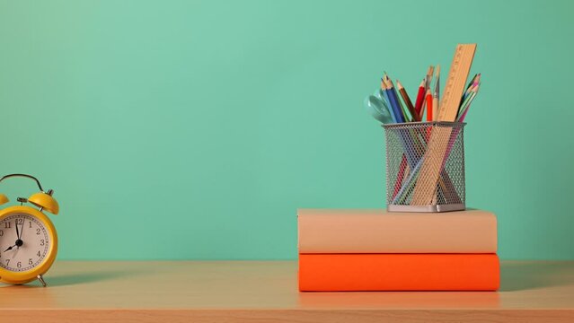Back to school background. Books and school supplies are on the desk. Stop motion