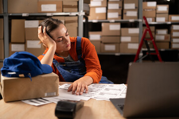 Tired stress woman worker labor working in warehouse cargo inventory industry sleep on workplace at...