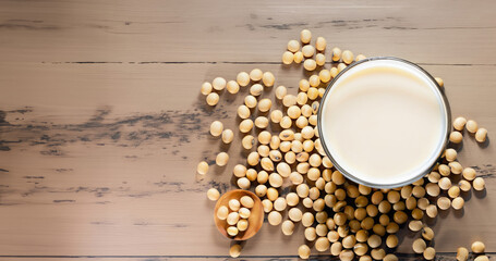 Soy milk milk and seed on the wood table, shoot from above, copy space