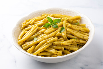 Casarecce pasta with cilantro pesto sauce on a grey background, top view. Delicious vegetarian lunch.