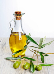 Green fresh olive and olive oil isolated.