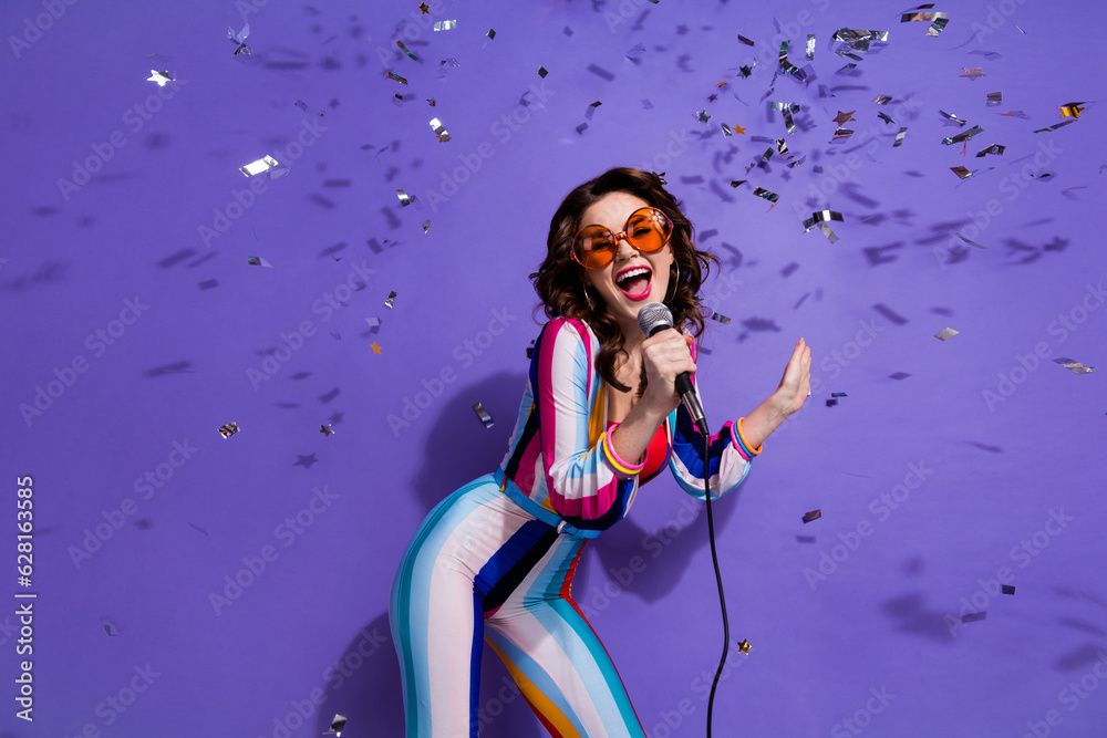 Wall mural Photo of cool funky lady wear striped overall dark glasses enjoying discotheque singing songs isolated purple color background