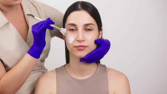 Slow motion portrait young woman uses creams of her face. Concept for fresh moisturized skin beautiful closeup cosmetic face happy healthy model. Young blonde hair woman take care of her skin.