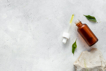 Obraz na płótnie Canvas Medical herbs cosmetic background - face serum essential oil in bottle