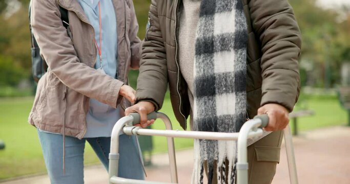 Nurse, support and walker with hands of old woman in park for help, person with a disability in retirement. Elderly care, nursing and closeup of caregiver and patient walking in nature for healthcare