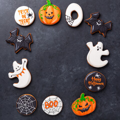 Halloween greeting card with copy space. Set of Halloween gingerbread cookies on dark stone background