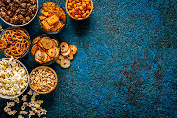 Many bowls of snacks for party - chips popcorn and nuts