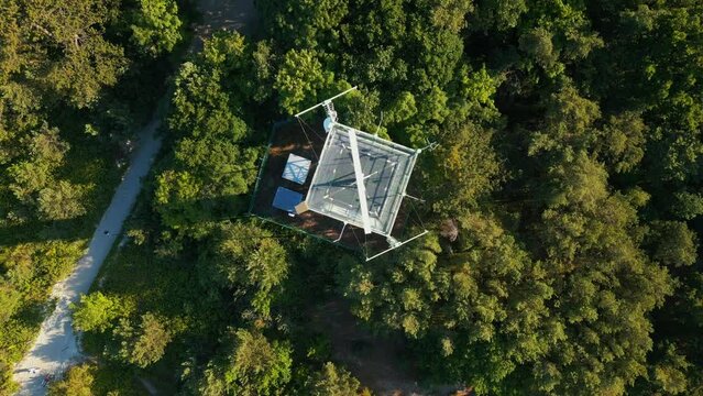 border observation tower with radar and antenna at sea shoe in forest, 4k aerial