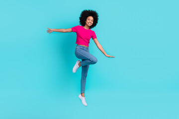 Fototapeta na wymiar Full length photo of crazy carefree person jumping rejoice empty space isolated on bright teal color background