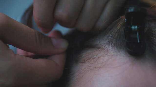 Process of weaving making boxer braids cornrows by a hair braider.