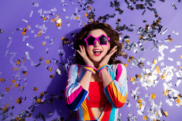 Top high photo of positive surprised lady in 70s style clothes lying discotheque floor isolated on vivid color background