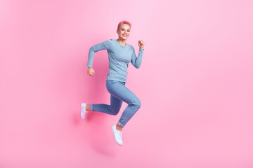 Fototapeta na wymiar Full size photo of pleasant pretty nice girl dressed blue shirt pants running shopping empty space isolated on pink color background