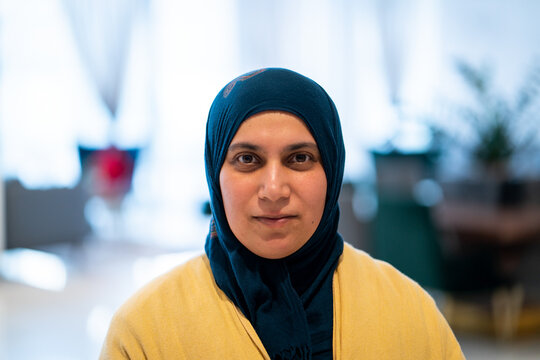 Positive adult Middle Eastern woman with hijab