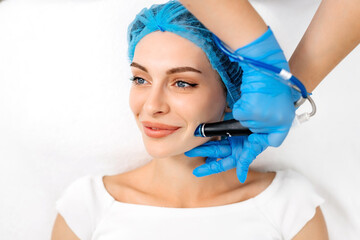 Beautiful young woman enjoying a hydrafacial treatment at the beauty salon.