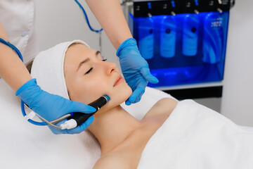 Facial skin care machine in spa clinic for anti-aging or acne treatment. The concept of aesthetic...