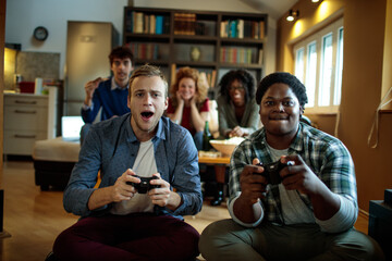 Young people playing video games in the living room on a gaming console