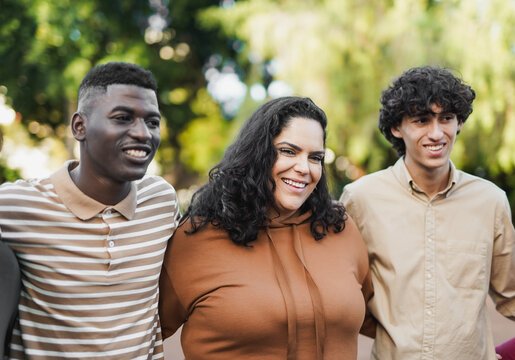 Young diverse people hugging each other outdoor - Curvy woman smiling on camera