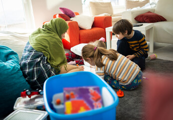 Muslim young teacher with small group of children having school learning