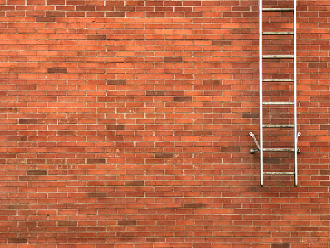 Safety exit ladders on brick wall