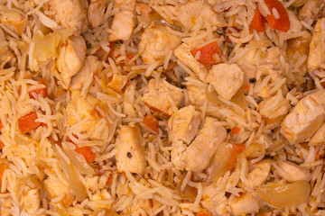 Tasty pilaf with chicken as background.