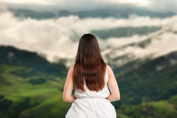 Fototapeta na wymiar Young beautiful happy woman traveling in the mountains, vacation