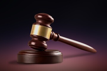 Judge's wooden gavel or hammer with a stand.