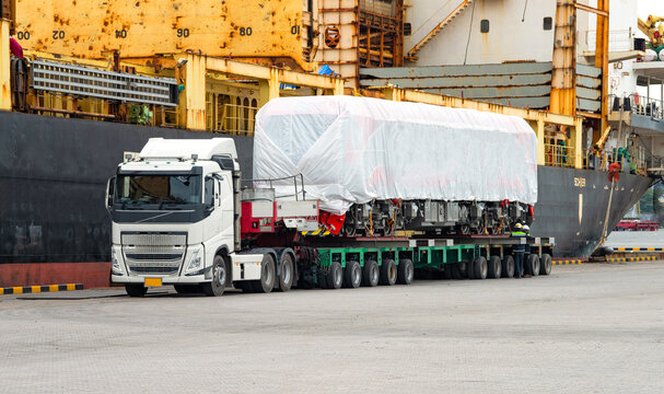 Transport of Oversize Heavy cargo trailera new diesel-electric locomotive on a multi-axle hydraulic modular truck trailer Loading a port area