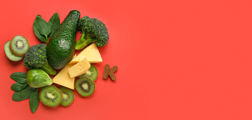 Composition with healthy products containing vitamin K on red background with space for text