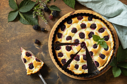 Homemade blackberry pie. Vegan gluten-free pastry, vegan desserts. Sweet pie with blackberry and custard on wooden table. View from above. - Powered by Adobe
