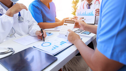 Medical staff meeting to discuss Vinichaya disease by using a tablet, graph paper showing results. and many medical devices that was explained at the meeting medical concept © ThawKyar
