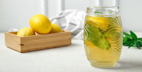 Glass of ice tea on light table, closeup