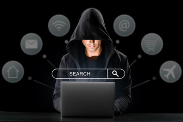 Hacker with laptop using web search engine on dark background