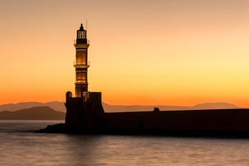 Old Venetian lighthouse with a colorful sunset