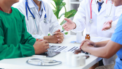 Medical staff meeting to discuss Vinichaya disease by using a tablet, graph paper showing results. and many medical devices that was explained at the meeting medical concept © ThawKyar