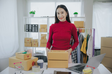 Beautiful asian woman wearing red shirt, presenting fashionable clothes, live video, social media, her record, selling online via digital camera, sme or small business ecommerce concept.