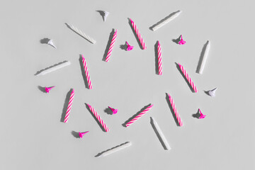 Frame made of birthday candles on grey background