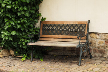 a decorative wooden bench in front of a house
