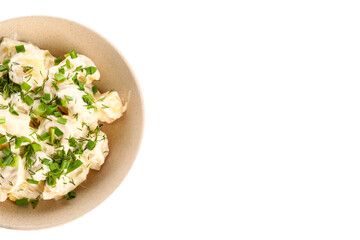 Bowl of tasty Potato Salad with greens on white background, closeup